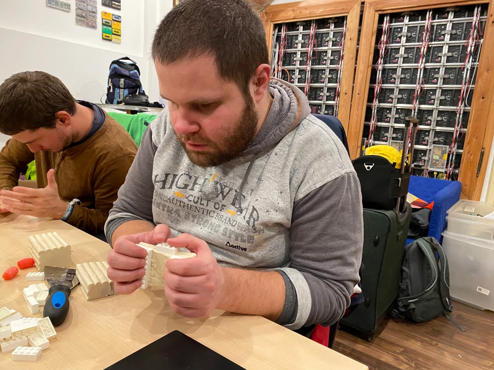 Jugendlicher mit Prototyp aus Knetmasse einer mobilen Tastatur in den Händen. Die Finger liegen auf Legosteinen statt Tasten.